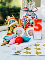 An image of the "CandyGram" featuring a bag of candy, a candle, stickers, balloons, glasses, a crown, and more
